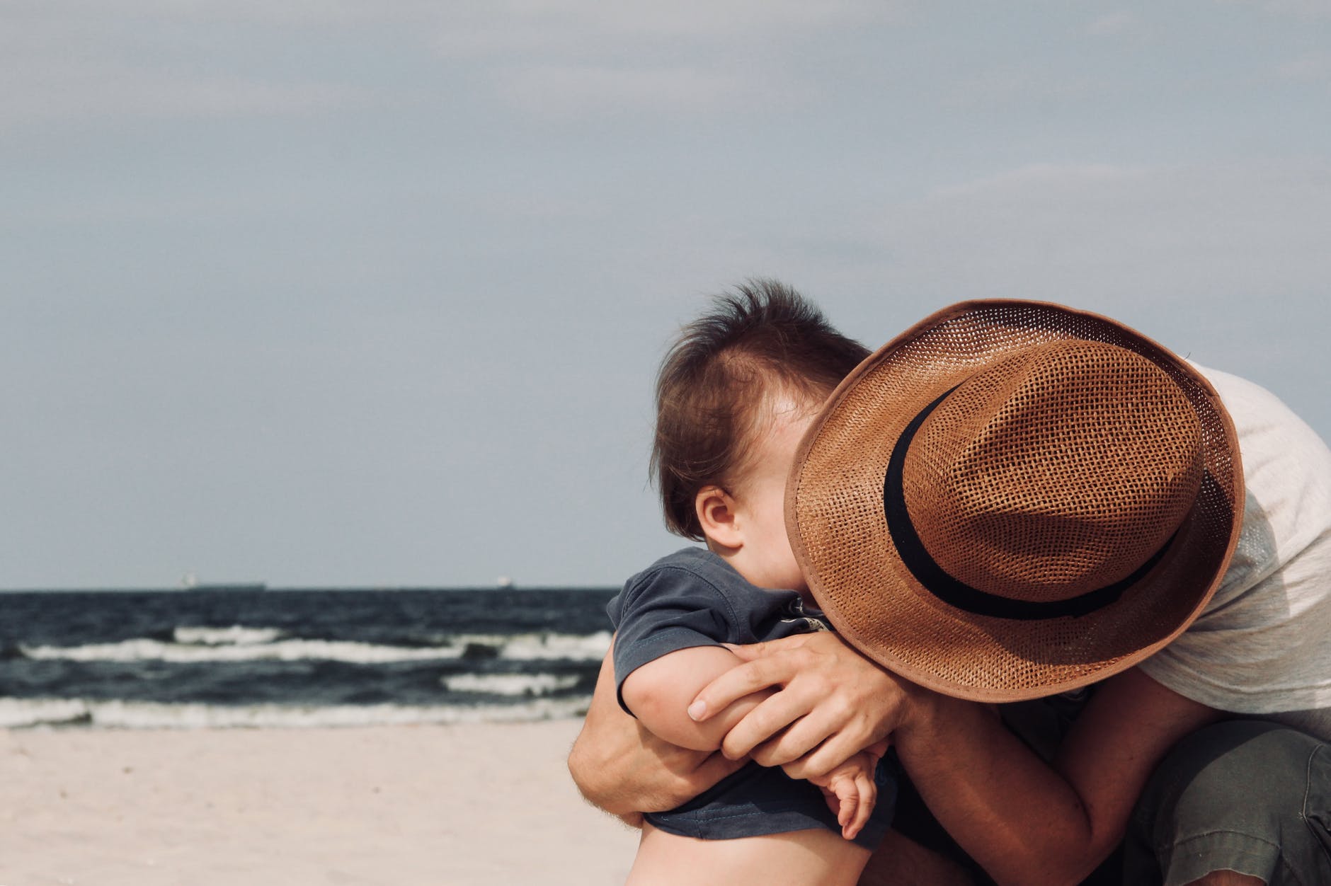 photo of person holding his baby